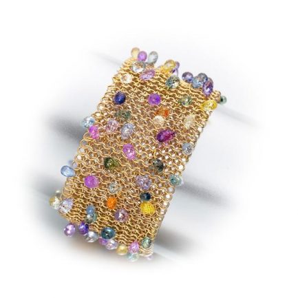 Multicolour sapphire briolletes set into an 18 carat gold mesh cuff